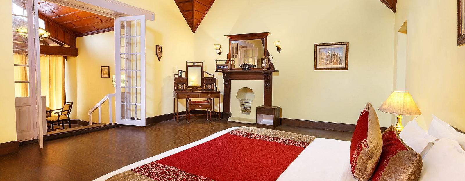 Hotel room featuring a cozy king-sized bed and wooden ceiling.