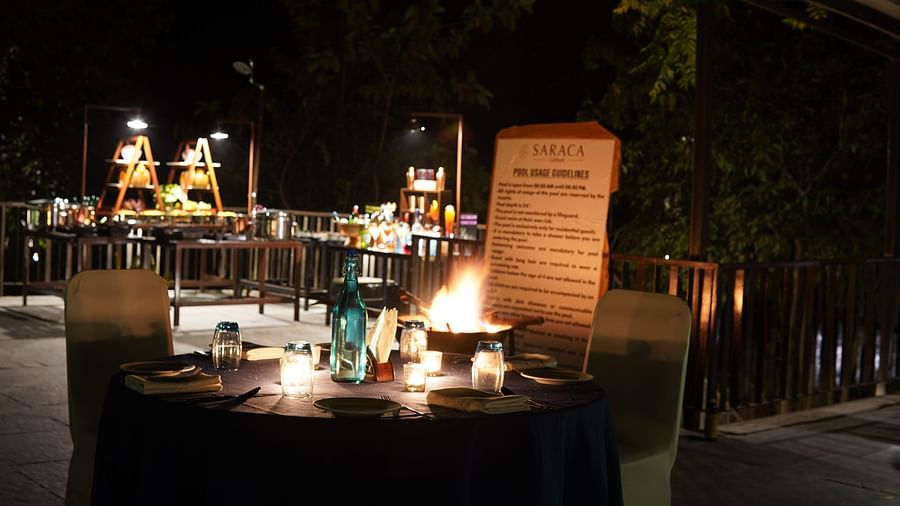 Outdoor candle light dining arrangement at Saraca Resort & Spa Corbett at night
