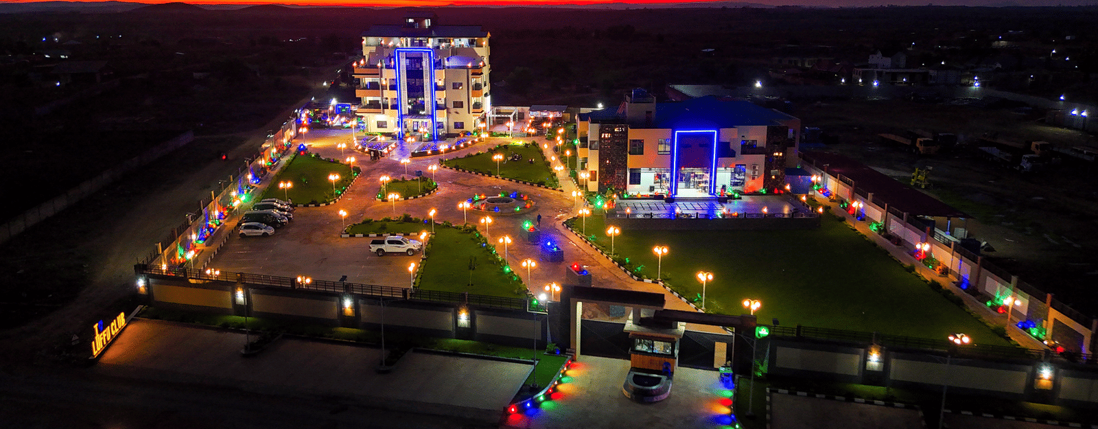 Exterior view of a building and grounds illuminated under bright orange sky - Luffu Club