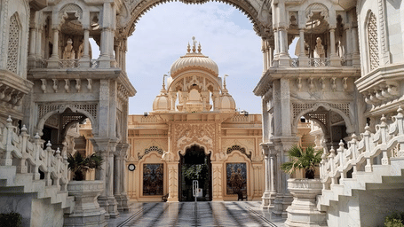  A grand white marble temple with a black and white checkered path leading to the arched entrance.