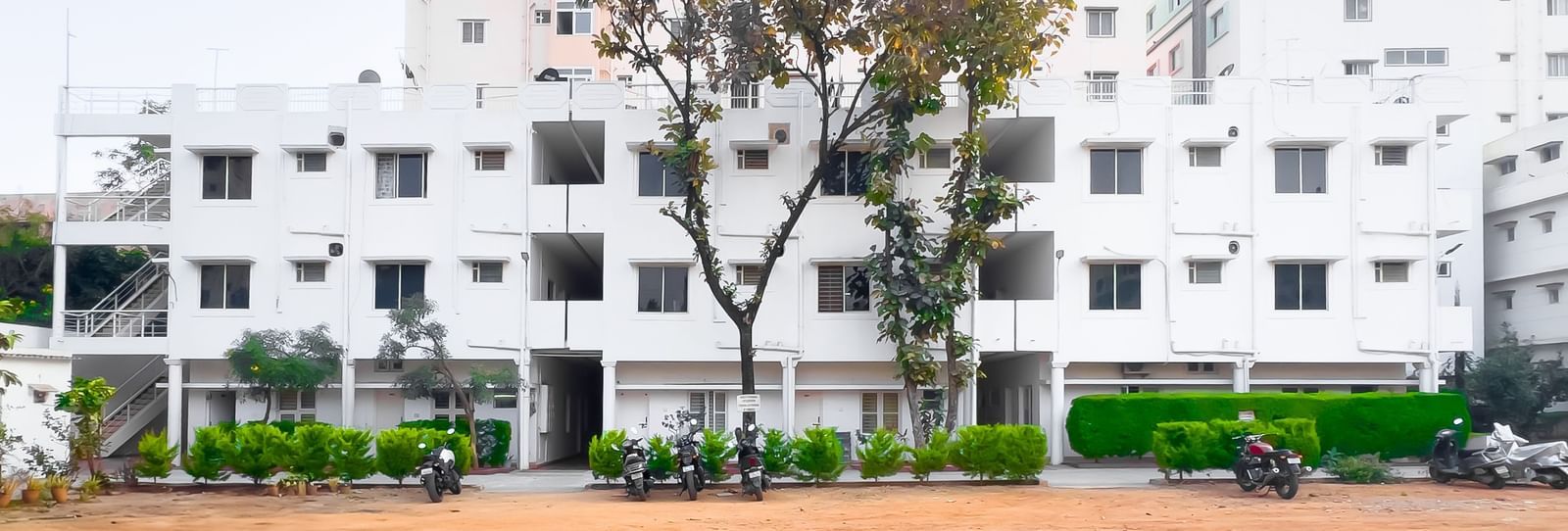 Wide outdoor area with apartment building in the background at The Pinnacle, Electronic City.
