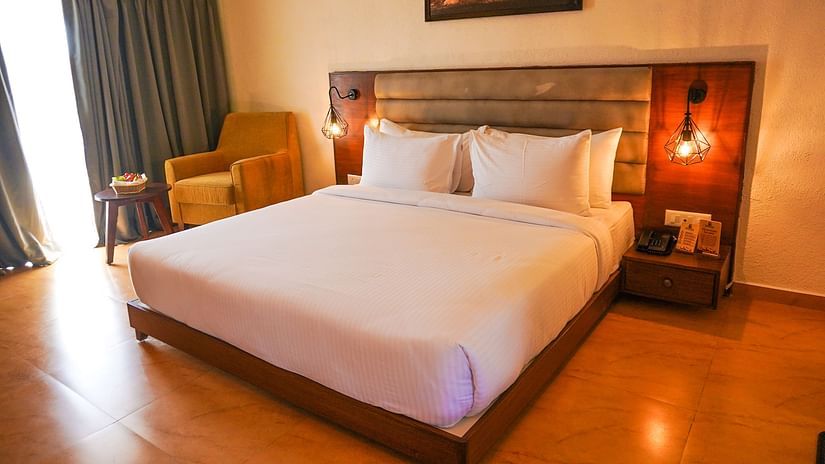 bedroom with white bed covers and other various other amenities at Jagira Ananta Elite 7