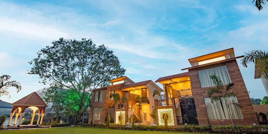 The facade of the villas set against the vivid blue sky - Wedlock Greens Hotel Resorts Dhanbad.