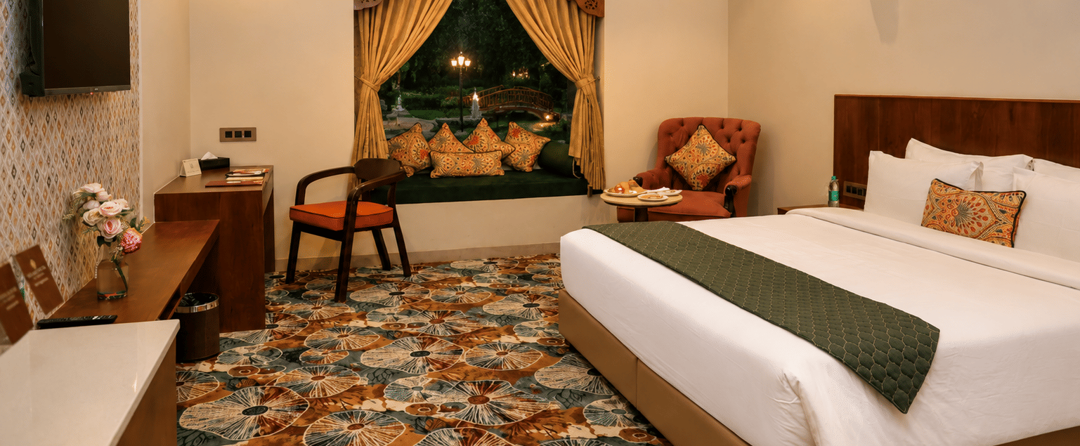 kadamb kuteer, vrindavan, featuring a spacious guest room with twin beds, traditional furnishings, decorative accents, and warm lighting