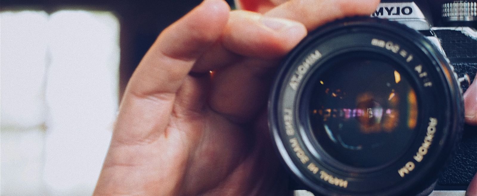 A hand holding a camera
