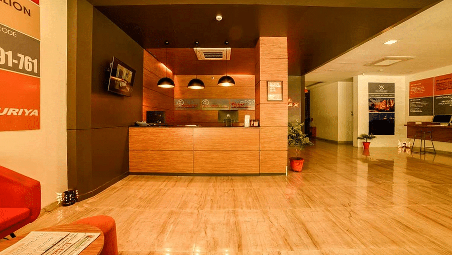 An image of a reception lobby featuring a reception desk , and a seating area for the guest - Max Hotel Jabalpur