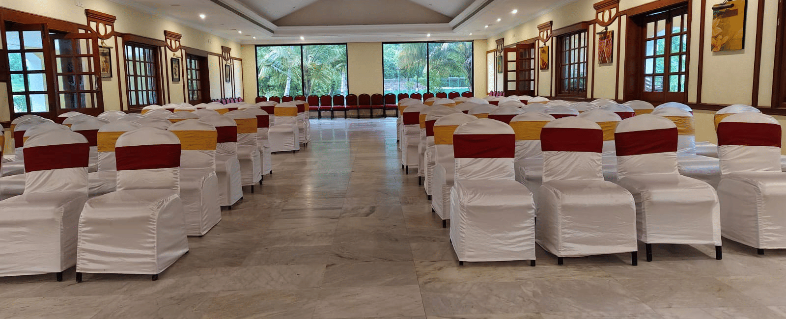 An event space at Avana Resorts, featuring decorated chairs and tables set for an event.
