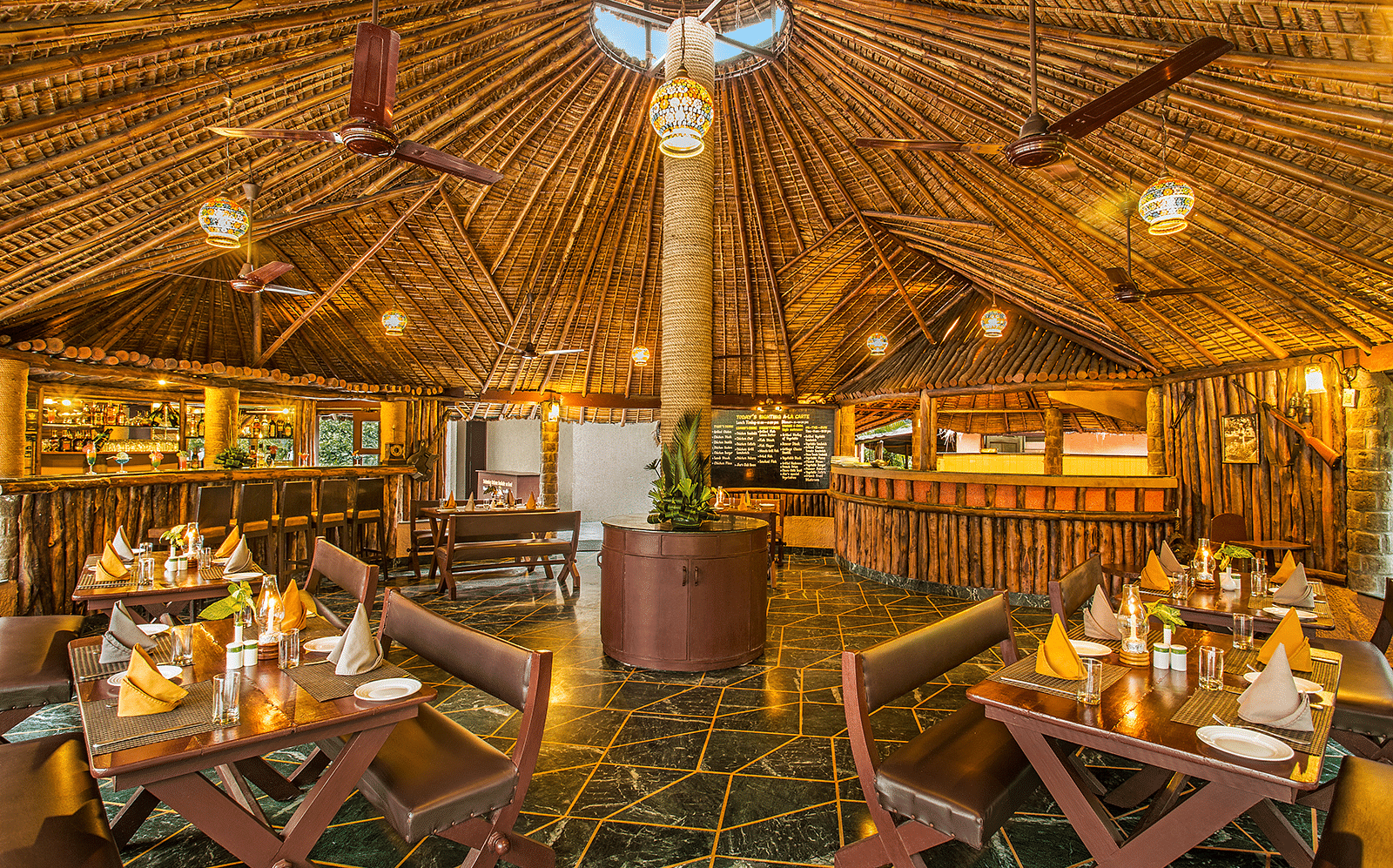 An image of a grill house with wooden interiors, wooden chairs and tables