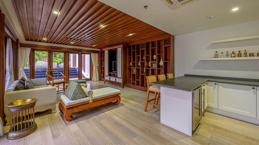 a corner view image of the living room with the adjoining kitchenette - three bedroom private pool villa