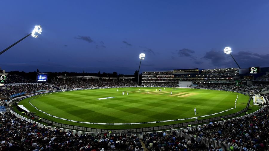 a full view of a stadium filled with with spectators watching a cricket match