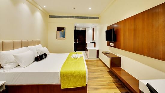 deluxe room with double bed, warm lighting and premium linens.