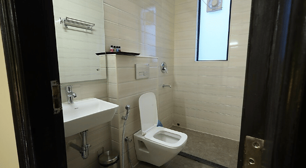 A neatly maintained washroom with white sanitary fixtures - Lime Tree Golf View, Golf Course Road