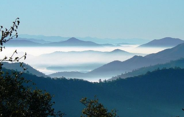An image of mountain peaks covered by clouds