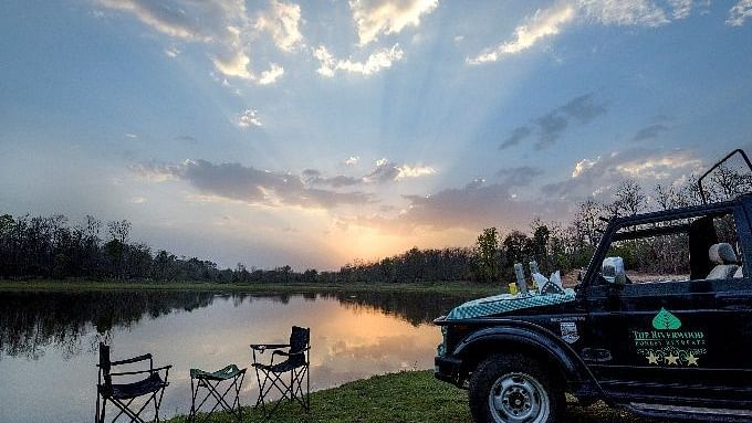 AN image of a jeep parked near a lake