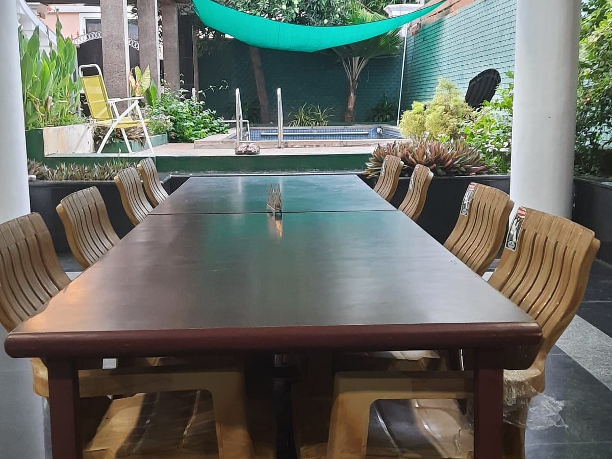 Image of a dining space with a table and chairs around it at Villa Serenity Le Sejour Pondicherry.