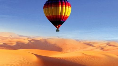 A hot air balloon gliding over the desert in Pushkar 