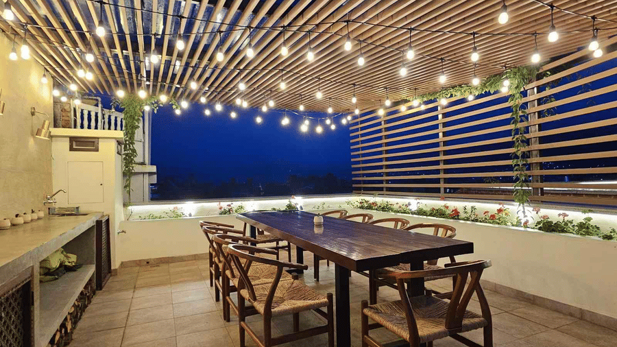 Modern dining area at The Nanee, Bhaktapur, Nepal. sleek furniture beneath parallel ceiling light strips and minimalist decor.