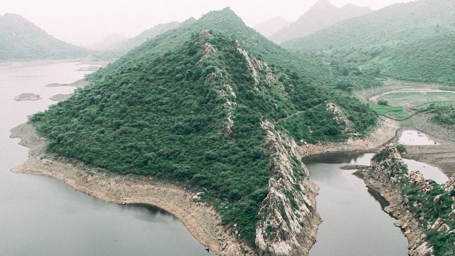A aerial view of a mountain in between a water body