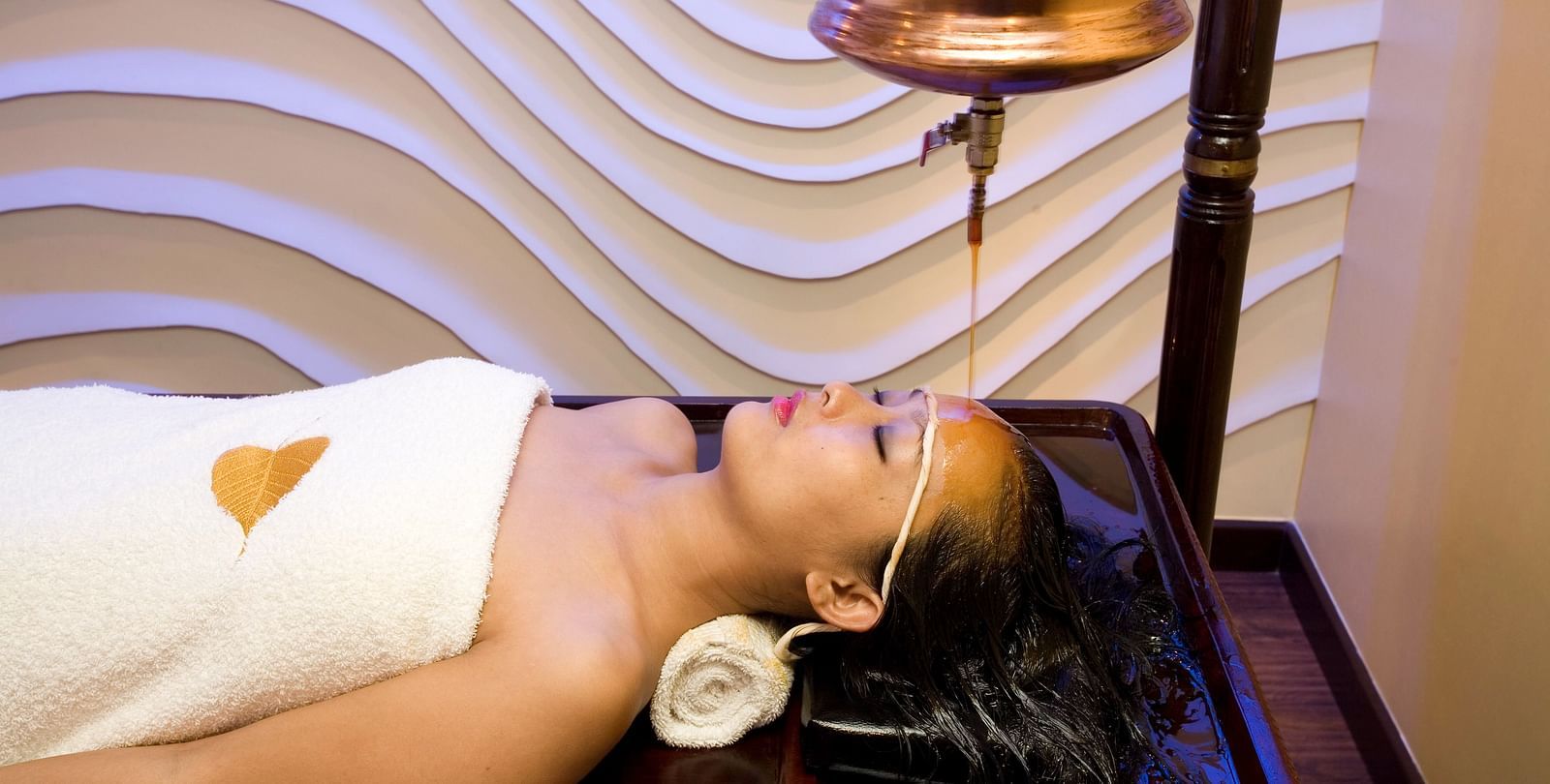 Lady getting a spa treatment at  Grand Chennai By GRT Hotels.