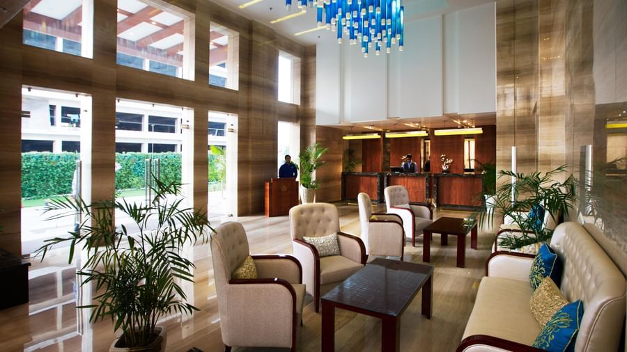 A lobby with a common seating area along with a beautiful chandelier hanging from the ceiling - Ramada by Wyndham, Ghaziabad, Vasundhara