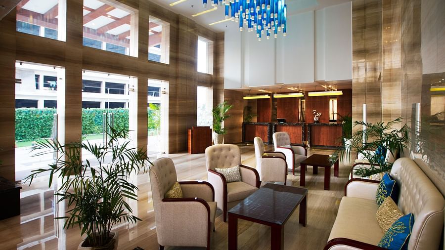 A lobby with a common seating area along with a beautiful chandelier hanging from the ceiling - Ramada by Wyndham, Ghaziabad, Vasundhara