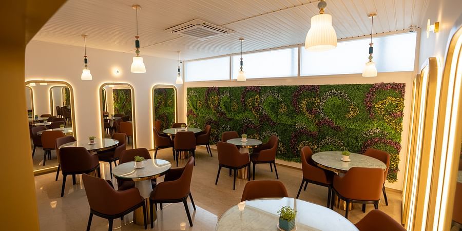 A bright, welcoming dining area featuring stylish seating and green accents.