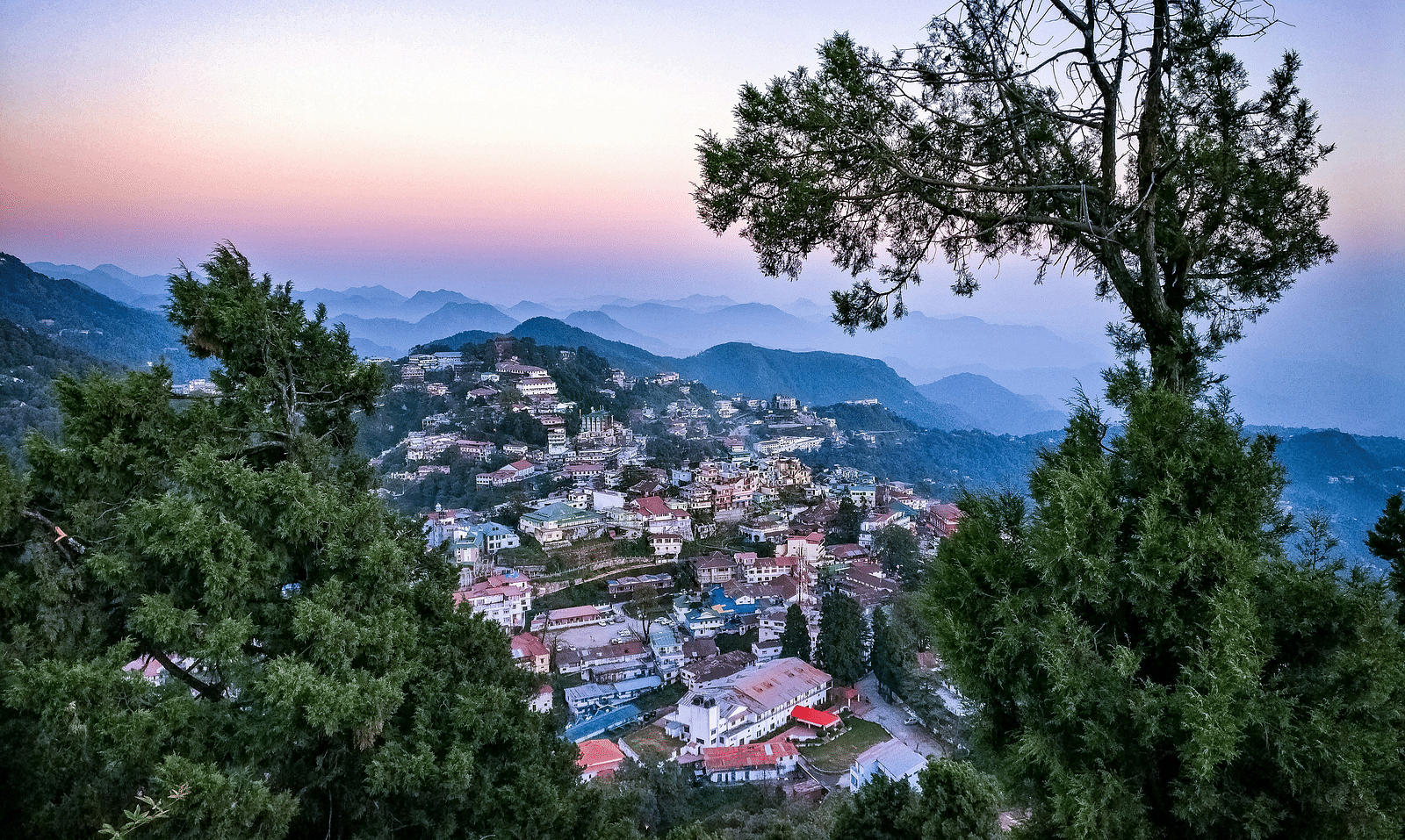 a bright facade image of a town from a hiltop
