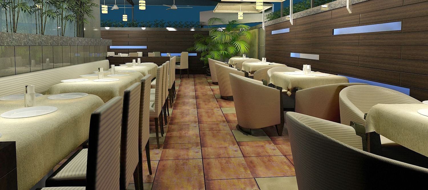 Outdoor dining area with chairs and tables arranged neatly, surrounded by plants at Oriental Aster, Mumbai.