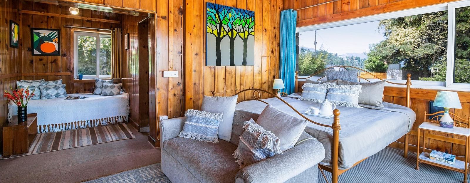 An mage of a master suite bedroom at avalon cottages with a seating arrangements near the window