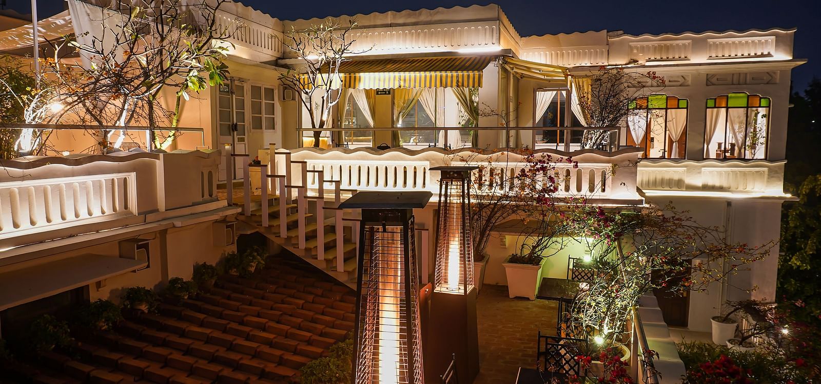 Exterior of well-lit Saraca Bar at Saraca Hotel, Lucknow at night