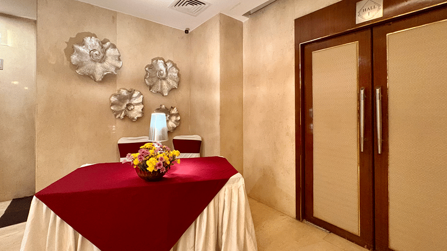 Dining table setup near the entrance of a banquet hall - Senses Hotel