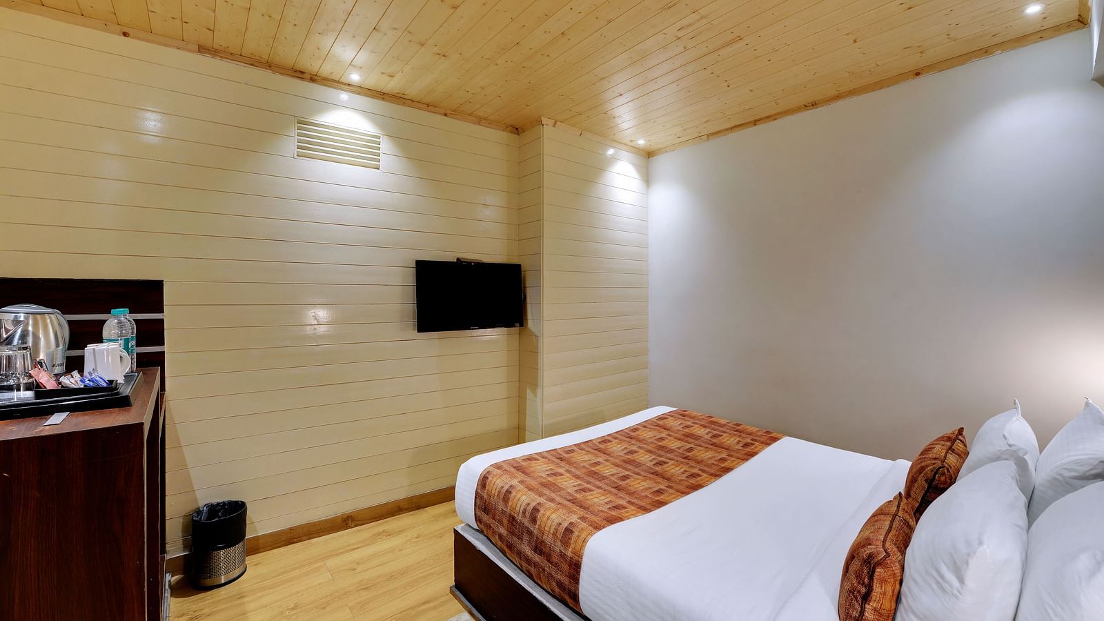 An image of a room with a queen size bed, TV and room amenities like tea coffee maker - Sumitel Vista TV Tower