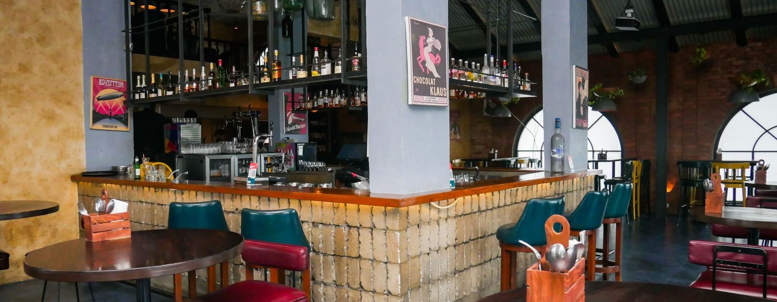 A stylish hotel bar with comfortable seating and a wide selection of beverages, inviting guests at Shilton Dee Cee.