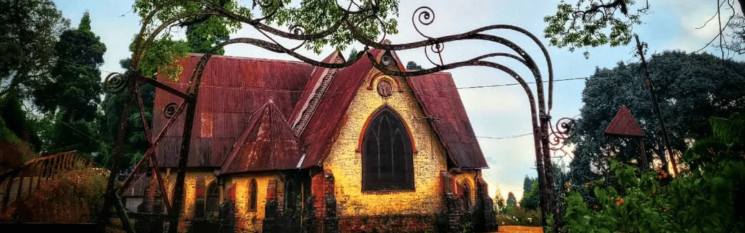Dow Hill Church in Kurseong surrounded by tall trees and greenery, a historic colonial-era church in Darjeeling hills known for its serene and heritage charm