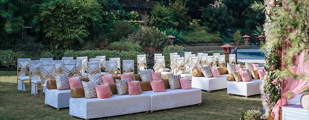  An image of a outdoor banquet hall with chairs and a stage decorated for destination wedding halls - Riverview Retreat, Corbett
