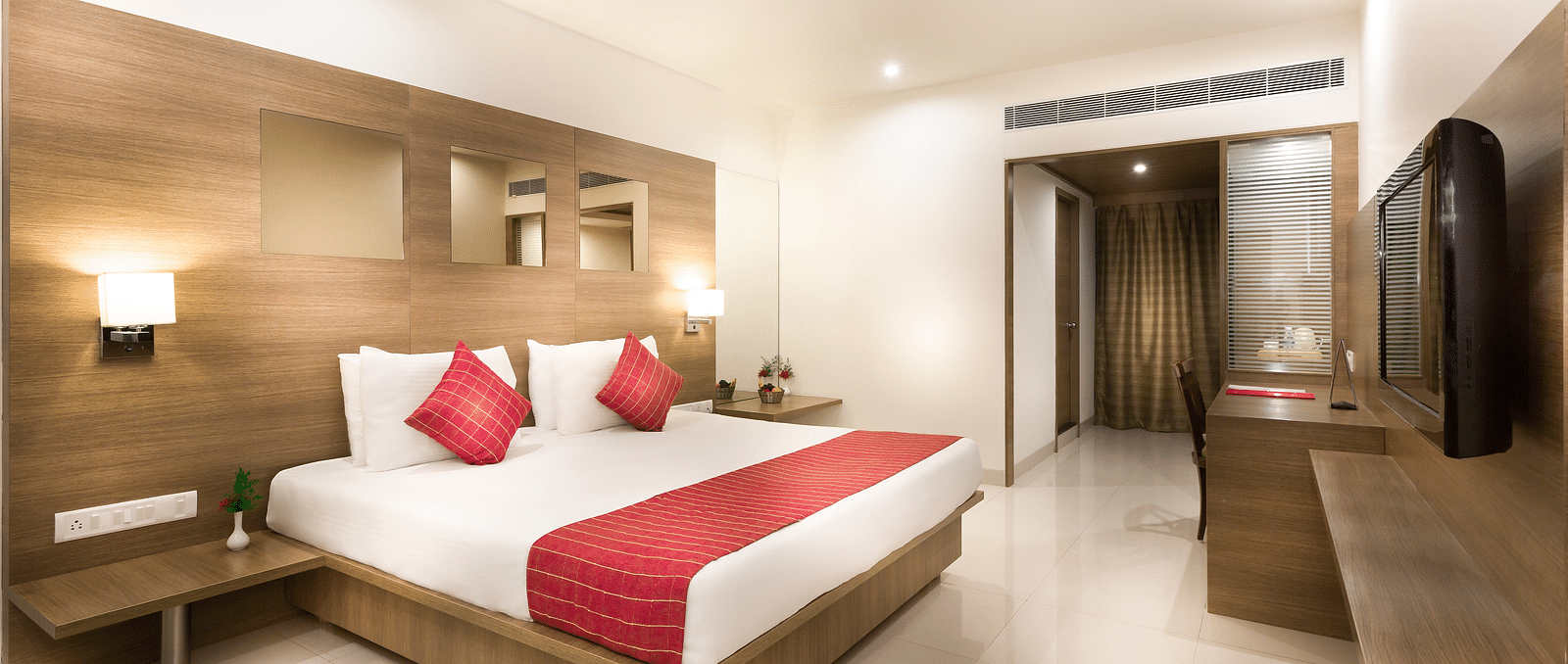 An image of a king size bed of a Deluxe Room at Regency Tiruttani by GRT Hotels.