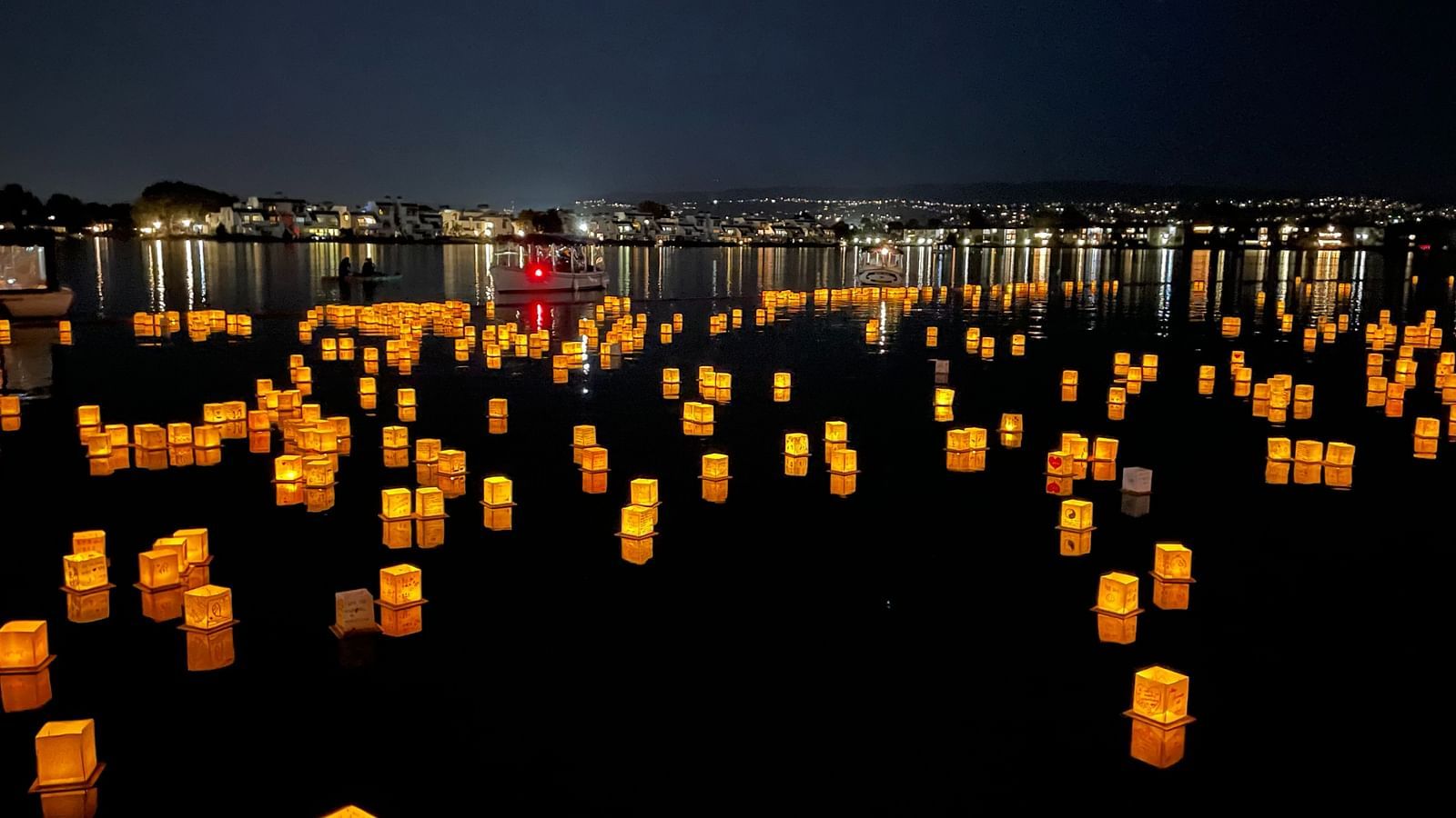 chinese lantern festival with yellow lanterns floating on water