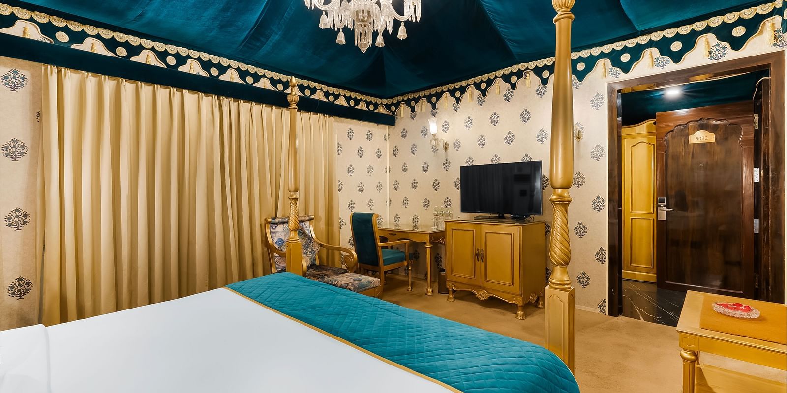 An overview of a tent with a close up shot of the double bed and a tv in the distance - Rajasthali Resort & Spa, Jaipur.