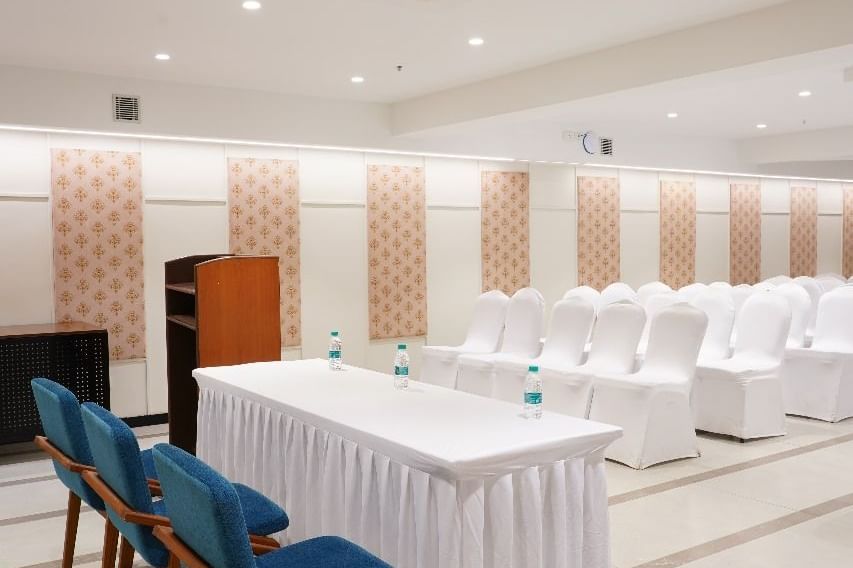 A bright meeting room with a long table and blue chairs, ideal for collaborative discussions at Shilton Dee Cee.