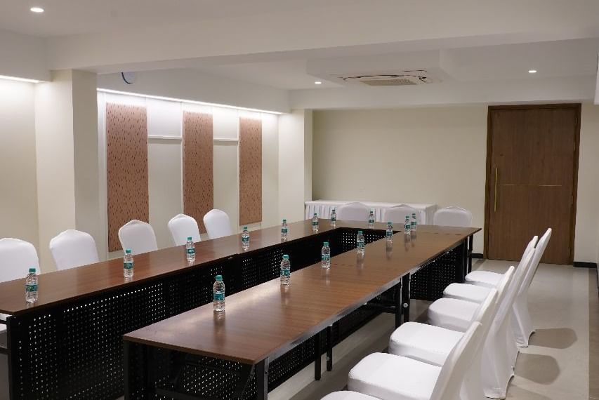 A conference room with a long dark table and white chairs, arranged for a productive meeting at Shilton Dee Cee.