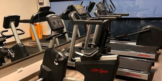 Fitness Centre at Sarovar Portico Outer Ring Road in Bengaluru featuring multiple treadmills that are placed the room.