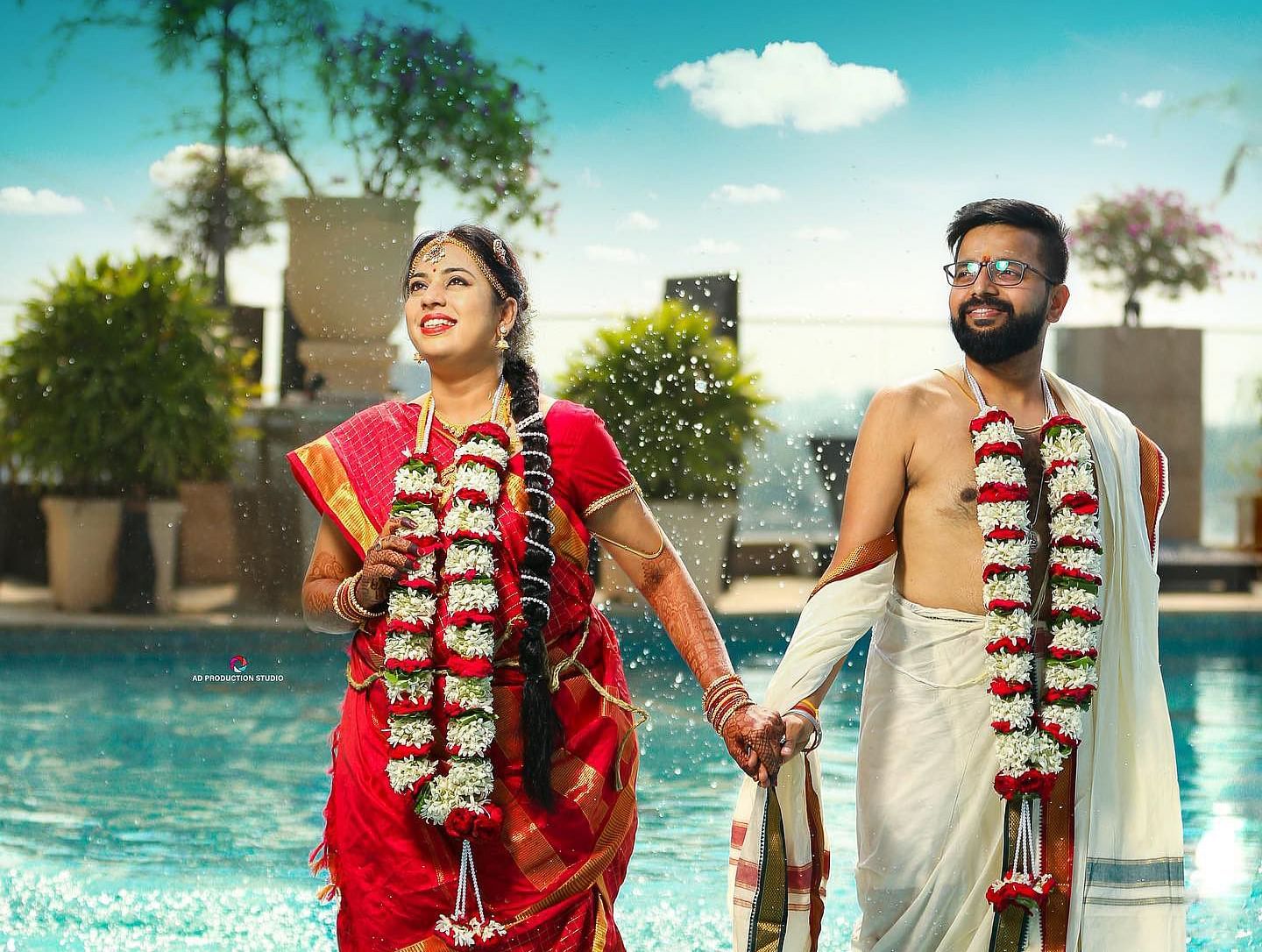 A couple posing for a photo-shoot in a swimming pool area. 