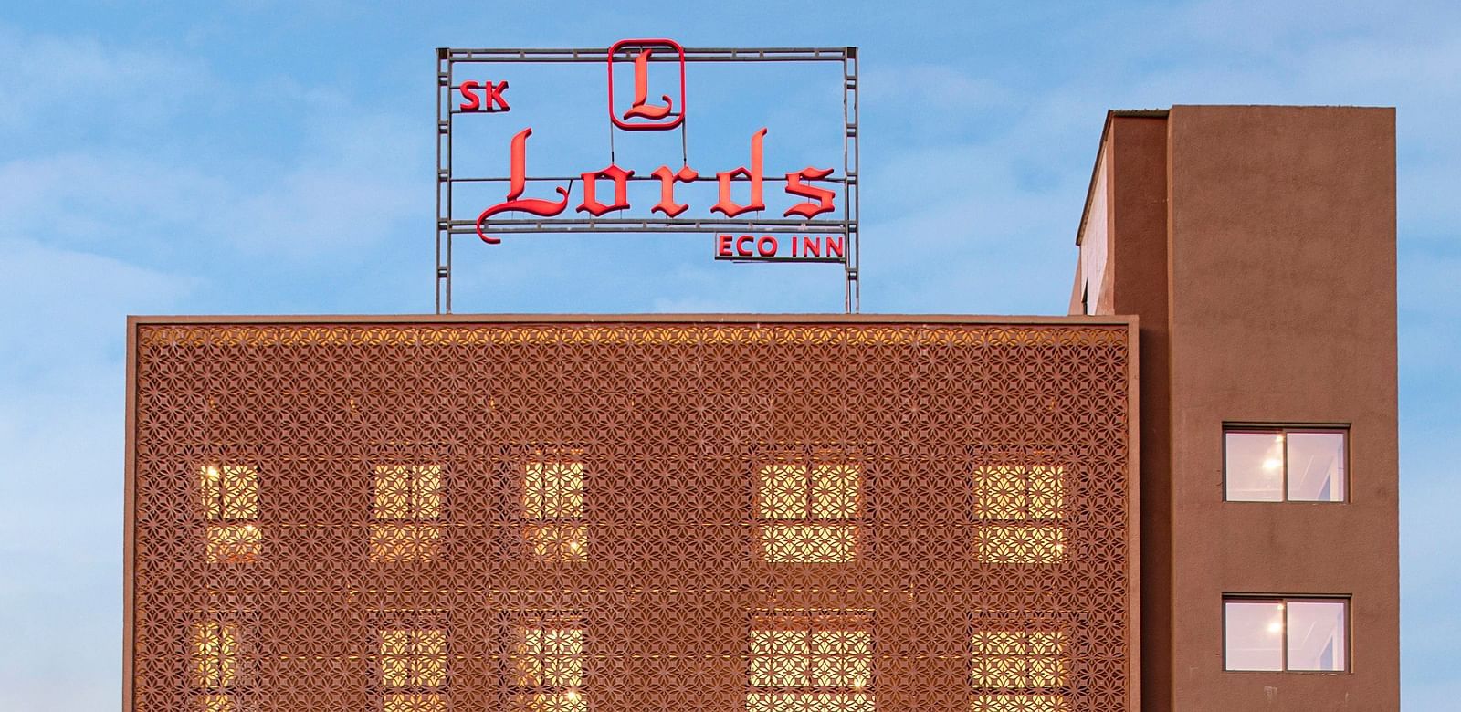 An exterior view of a modern, multi-storey hotel building - SK Lords Inn Ahmedabad