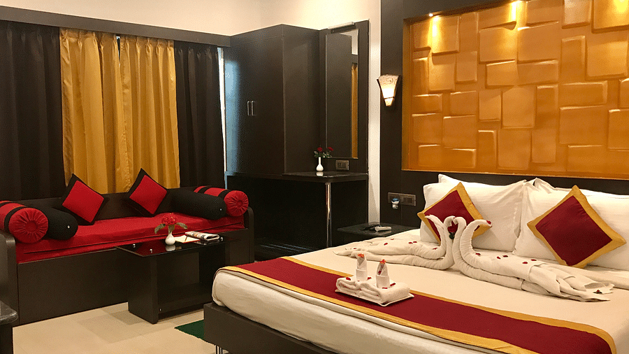 Image of a room with a bed with towels made into swans placed on it at Coorg Jungle Camp Backwater Resort, Kushalnagar.