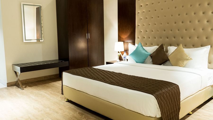 A large bed in Suite at Grand Ashok, Thanjavur.