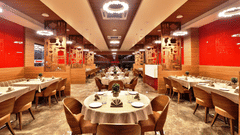 Seating arrangements inside the Kamats Restaurant with modern interiors - VITS Devbhumi, Dwarka