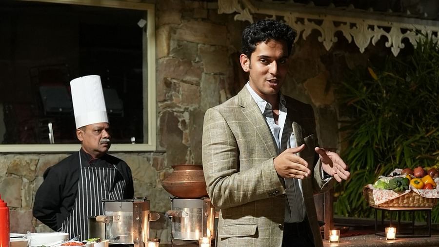 A guest engages with the culinary setup at an outdoor food counter - Khas Bagh, Jaipur.