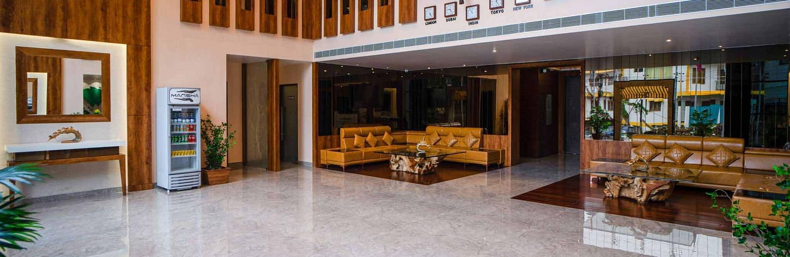 The spacious and elegantly designed lobby of Mansha Palace features warm wooden accents, comfortable seating, and a welcoming atmosphere.