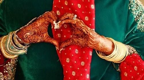a bride and groom posing for a picture at Wedlock Greens Hotel Resorts Dhanbad