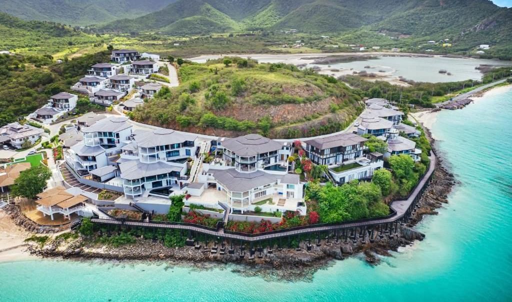 Ariel view of Tamarind Hills Resorts and Villas featuring the exterior of the resort surrounded by the sea.